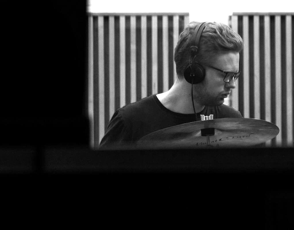 Monochrome photo of Matt Hartnell in a recording studio